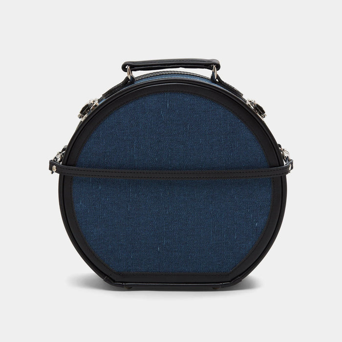Back product view of the small hatbox Editor linen suitcase with navy body, black trims and detachable suitcase strap