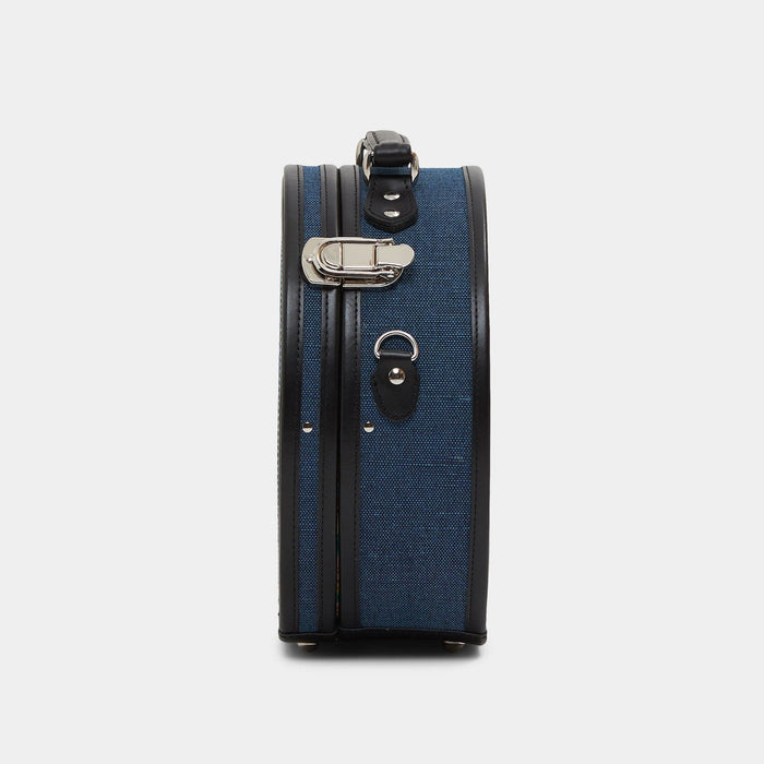 Side product view of the small hatbox Editor linen suitcase with navy body and black trims