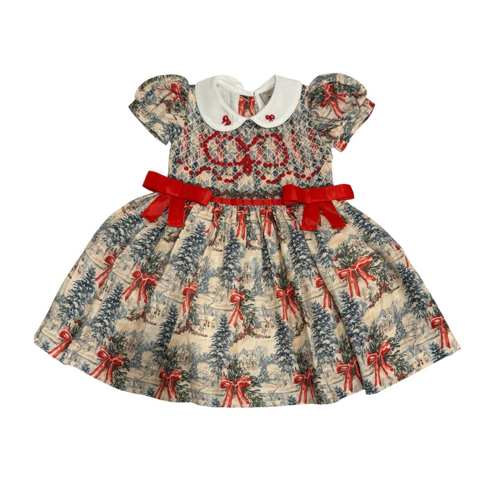 The Polar Express Bow Girl Handsmocked Dress in Christmas train toile print with red ribbon bows