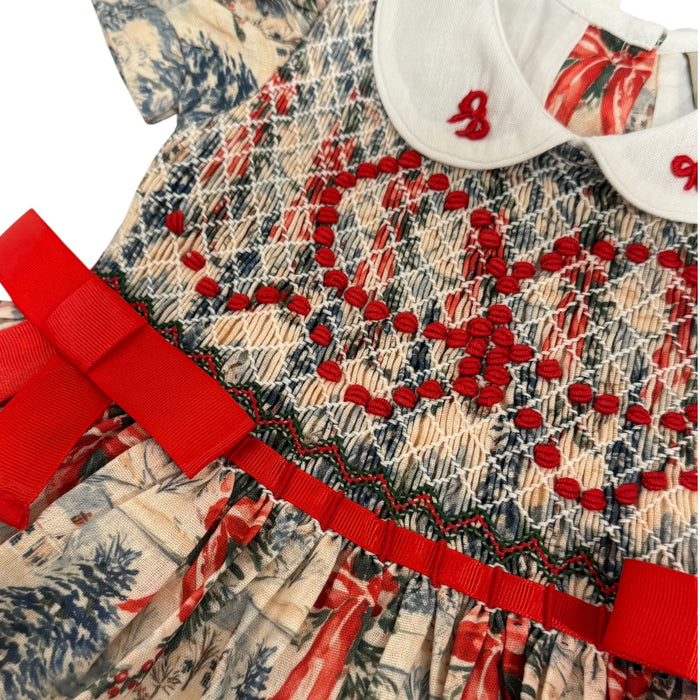 Close-up of handsmocking and red ribbon bow on The Polar Express Christmas dress