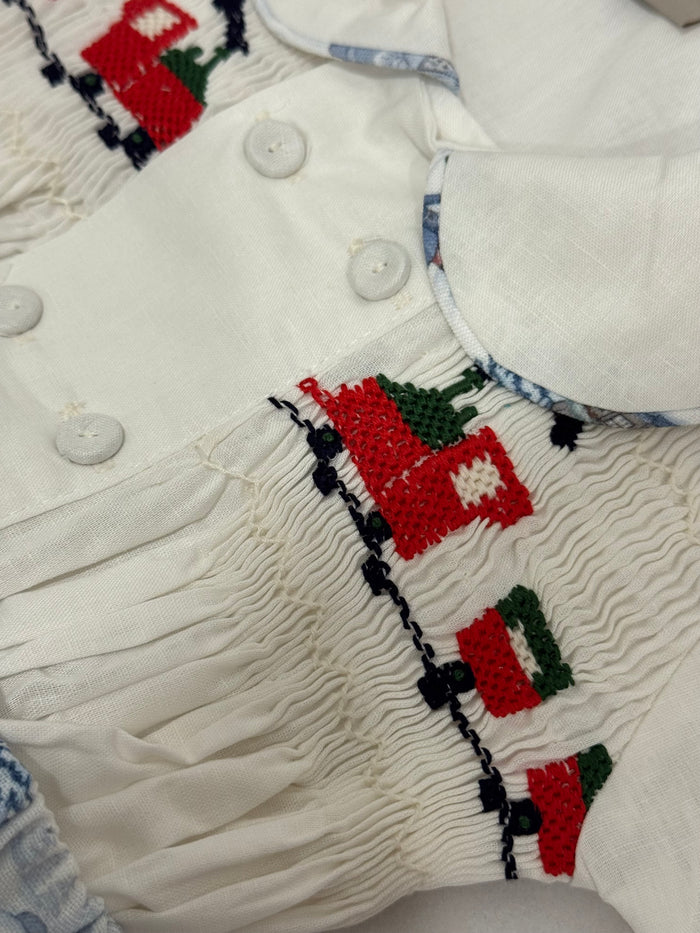 Close-up of handsmocked red-and-green train detailing on The Polar Express boy shirt