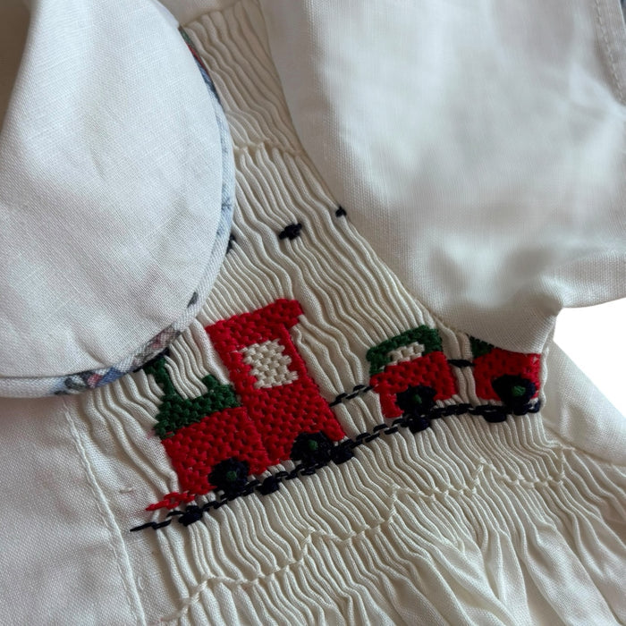 Close-up of handsmocked train and rounded collar on The Polar Express boy shirt