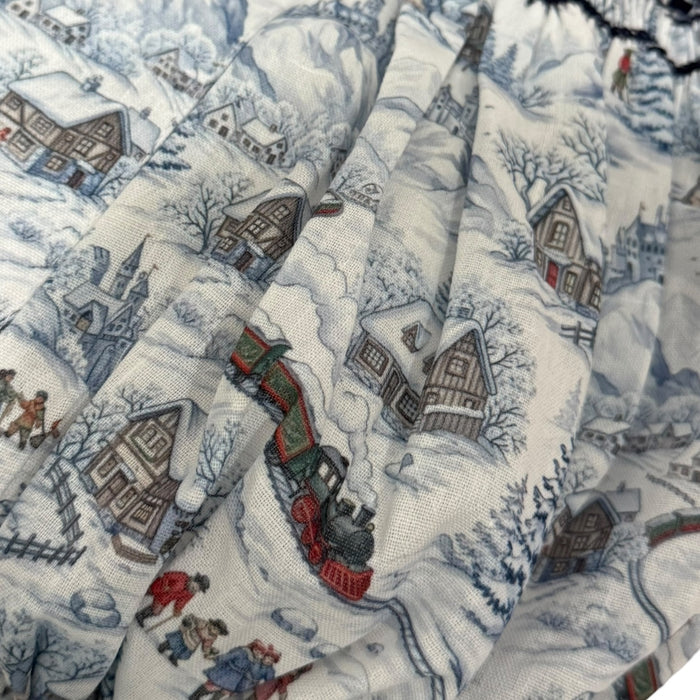 Close-up of snowy train toile print on The Polar Express Christmas romper