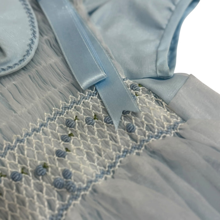 Close-up of light blue handsmocking and collar detailing on Theo Romper