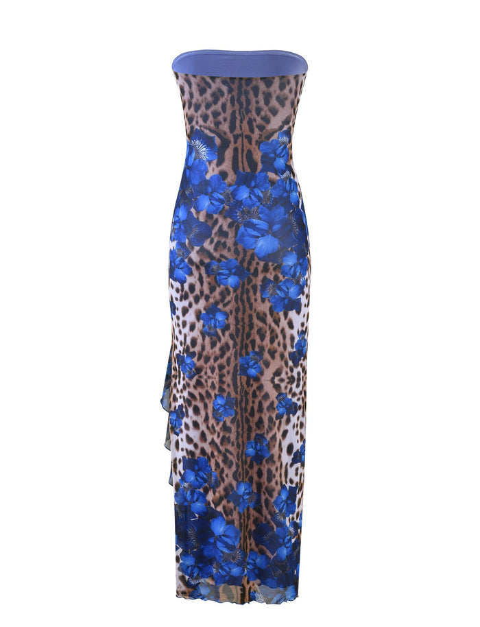 The Theo Maxi Dress by TigerMist showcases a body-hugging, strapless silhouette adorned with a striking fusion of leopard print and vivid blue floral patterns. Its floor-length design and sleek, smooth material add an elegant touch to this bold creation.
