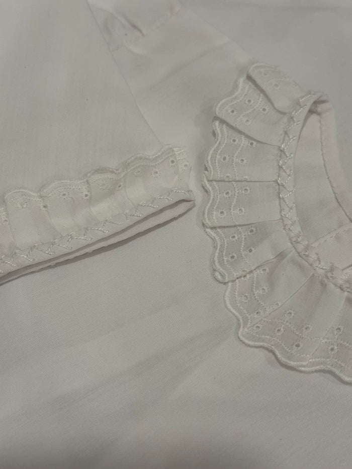 Close-up of white ruffled collar and sleeve detailing on Wayne Shirt